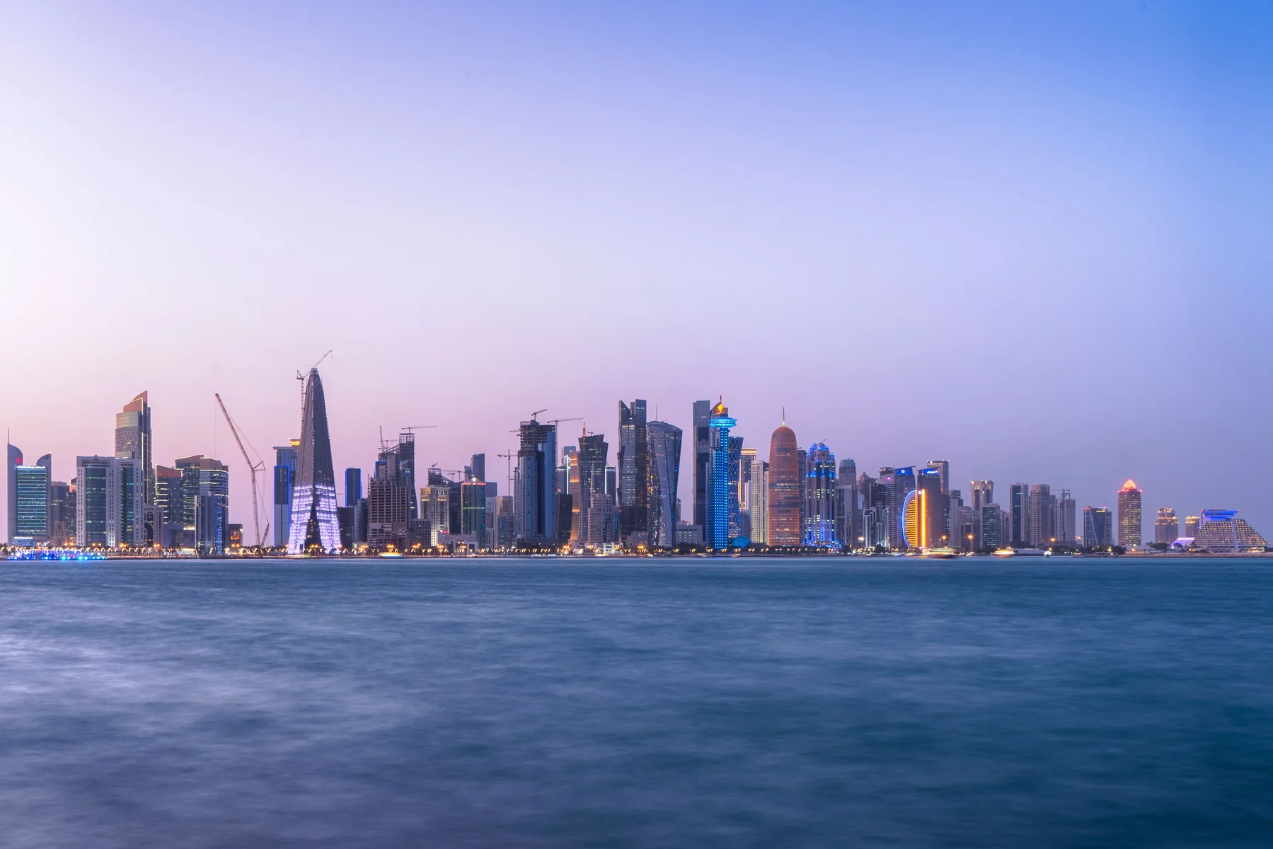 Doha's modern skyline beside the waterfront at twilight